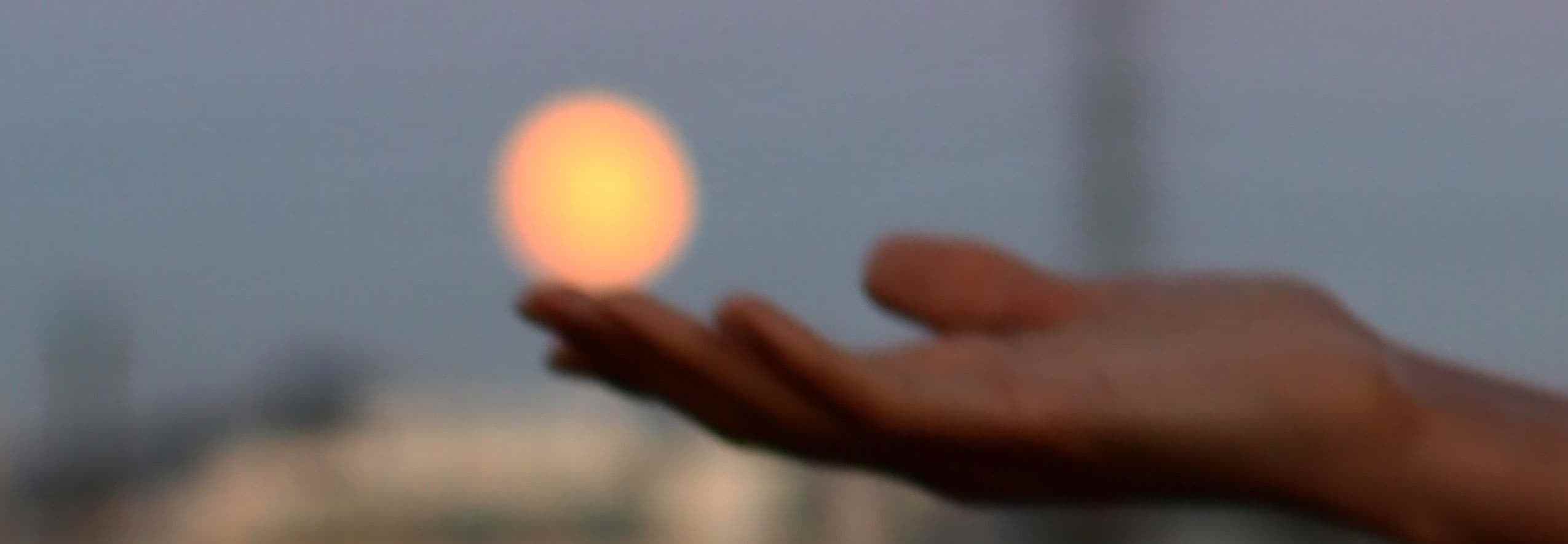 Hand holding sunset