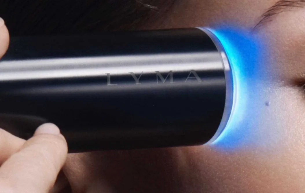 Woman uses the laser on face skin