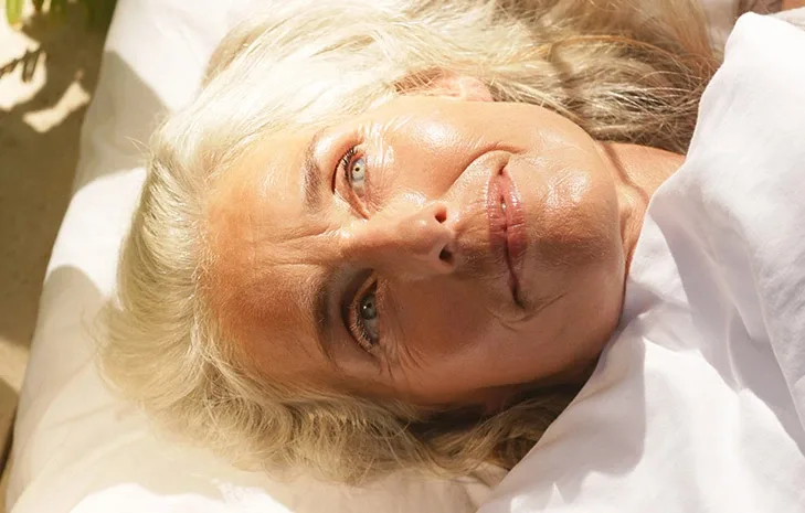 Closeup woman laying on pillow ageing sleep