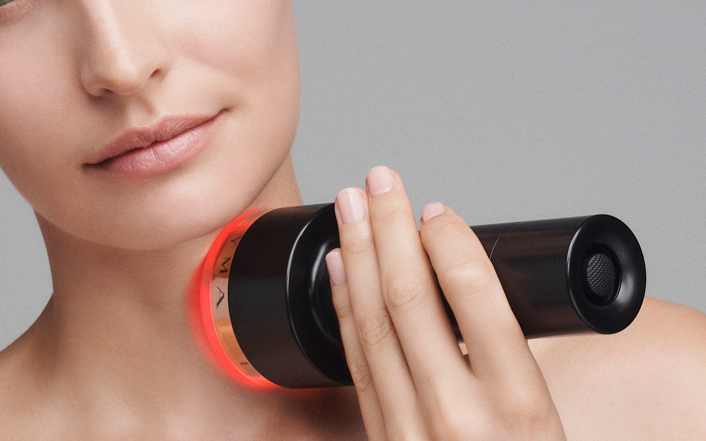 Emma Skeates holds the at-home Laser on face to smooth wrinkles.